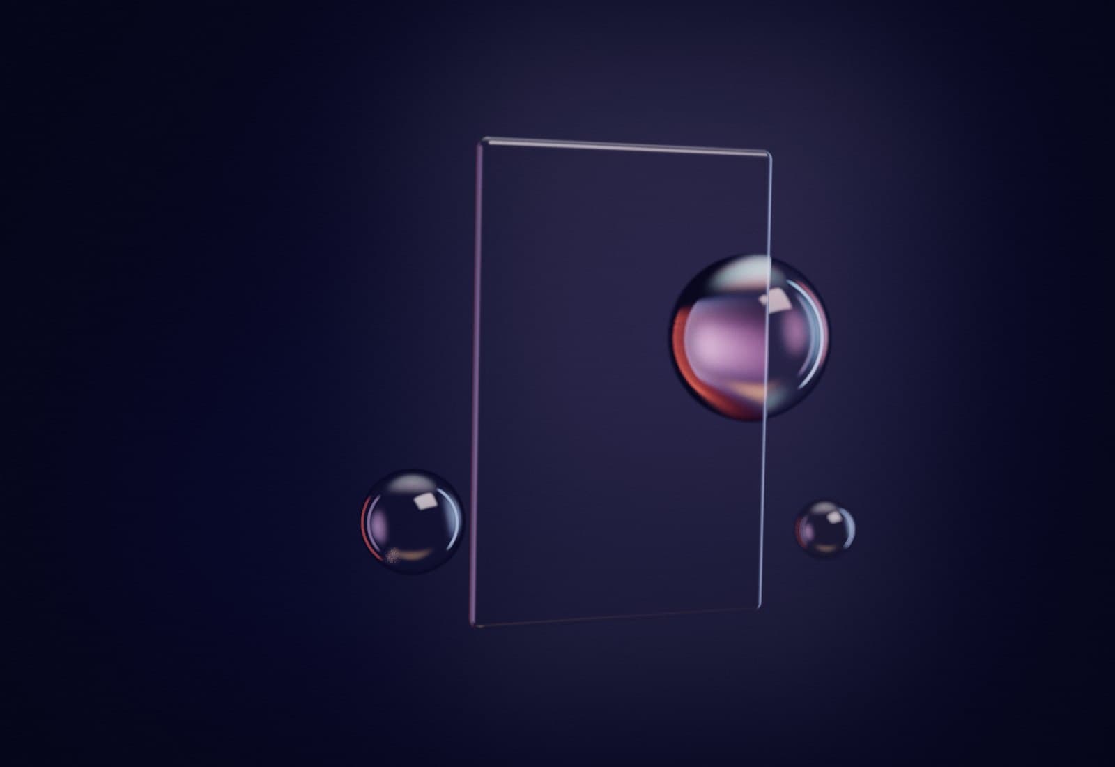 A frosted glass pane with an iridescent sphere half hidden behind it and two clear beads nearby.