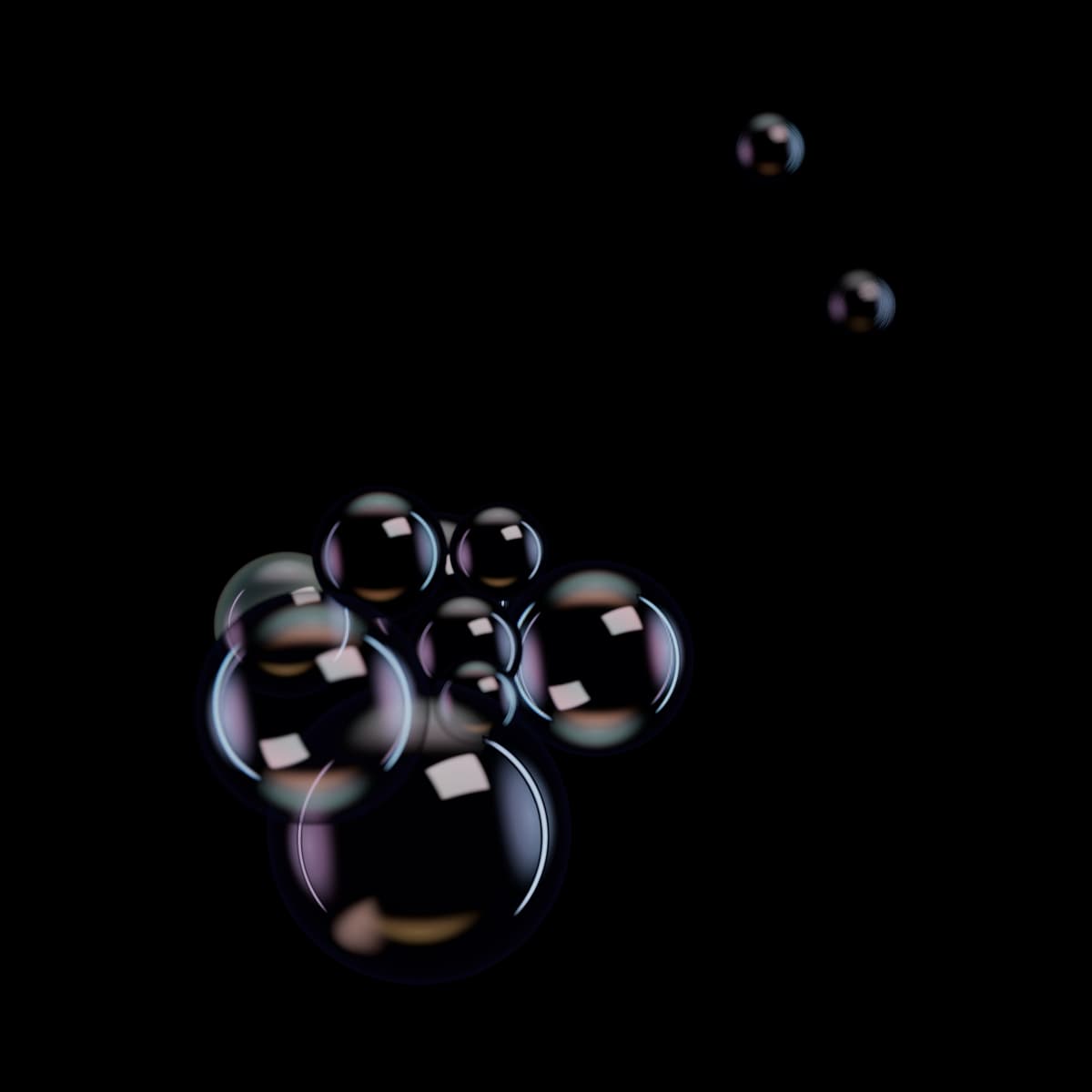 A cluster of clear glass and soap-film spheres of different sizes, with two small spheres drifting away from the group.